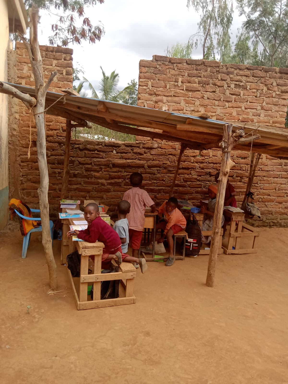 Children at Maviani Primary School in Kitui County, Kenya, inside an unfinished classroom.