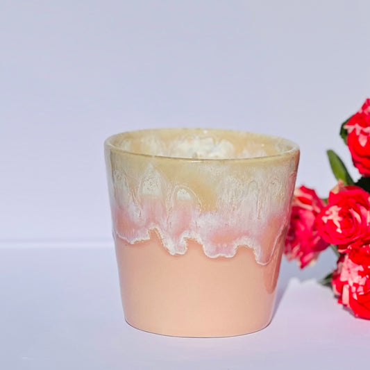 Aromatherapy candle in a pink-glazed stoneware coffee cup, made with natural wax and essential oils. Handmade by Kilimanjaro Candles & More, supporting young schoolgirls in Kenya.