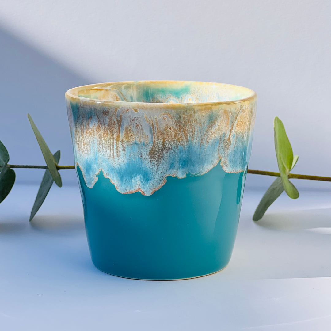 Hand-poured aromatherapy candle in a turquoise stoneware coffee cup, made with natural wax and essential oils. A soothing, eco-conscious candle by Kilimanjaro Candles & More.