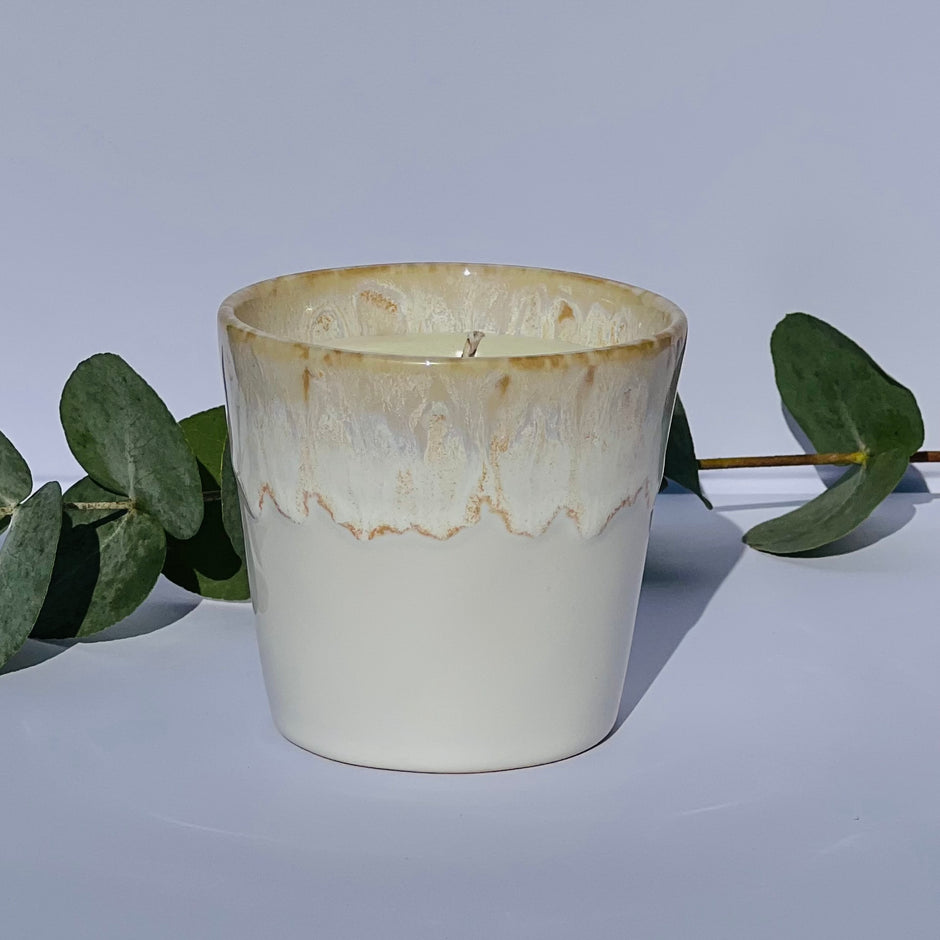 Aromatherapy candle in a white-glazed stoneware coffee cup, crafted with natural wax and essential oils. A handmade, eco-friendly candle by Kilimanjaro Candles & More.