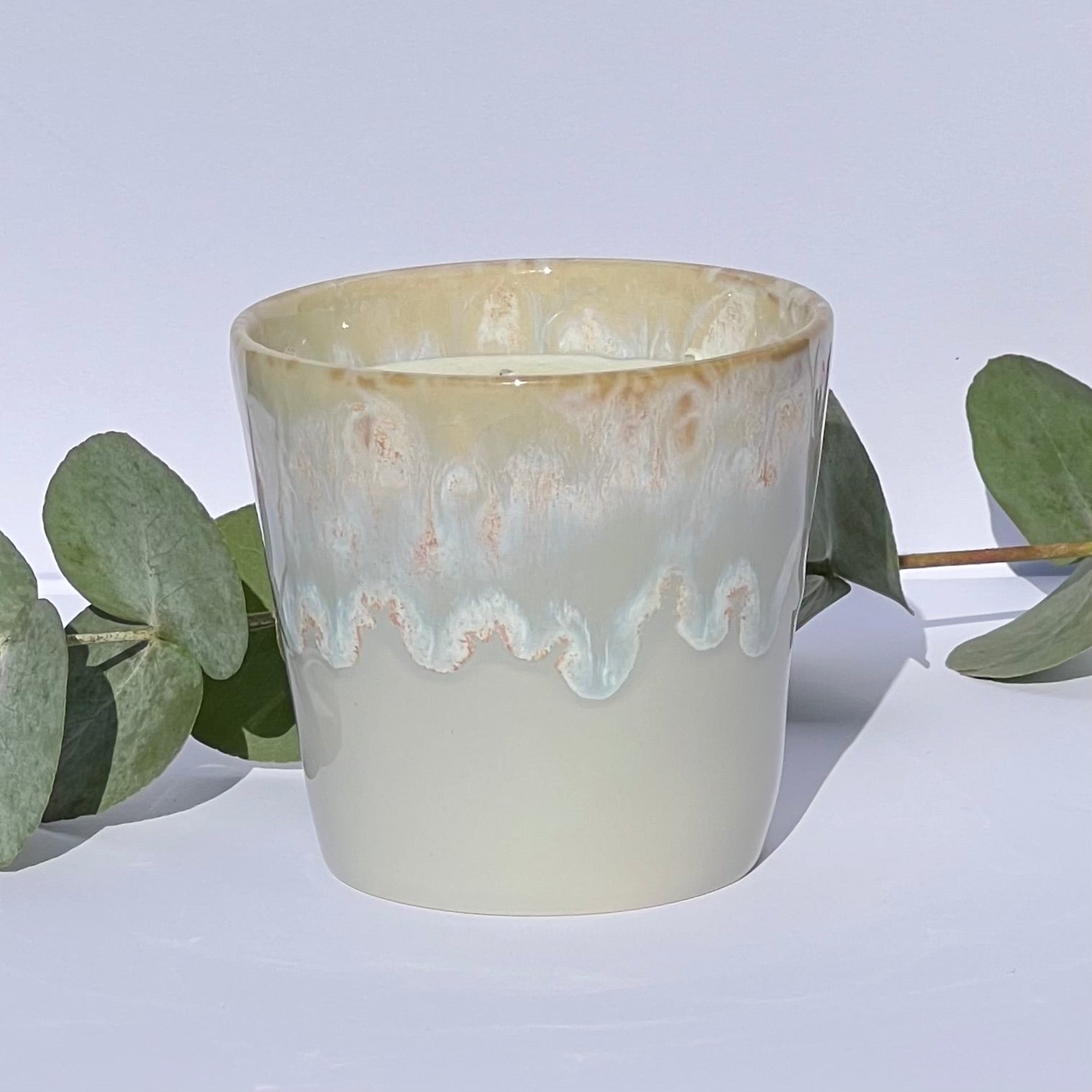 Handmade aromatherapy candle in a grey stoneware coffee cup, featuring natural wax and essential oils. A sustainable, artisan candle by Kilimanjaro Candles & More.