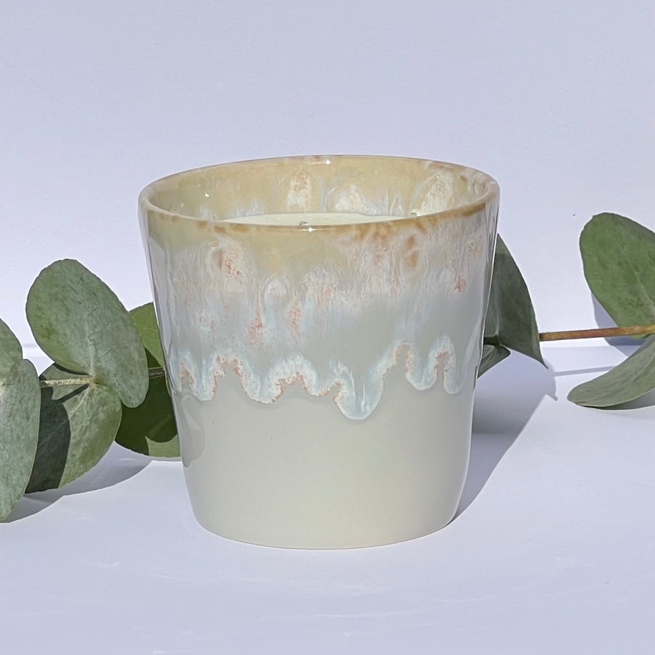 Handmade aromatherapy candle in a grey stoneware coffee cup, featuring natural wax and essential oils. A sustainable, artisan candle by Kilimanjaro Candles & More.
